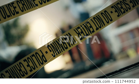 The crime scene in the apartment marked with warning tape, with the police collecting evidence The crime scene in the apartment marked with warning tape, with the police collecting evidence 111744952