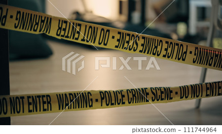 A close-up of warning tape at the crime scene, evidence preservation in the police investigation A close-up of warning tape at the crime scene, evidence preservation in the police investigation 111744964