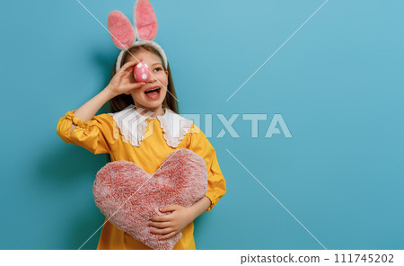 Girl with painted egg 111745202