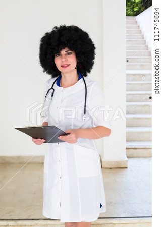 Portrait of a female doctor of European appearance on the stairs of a building Portrait of a female doctor of European appearance on the stairs of a building 111745694