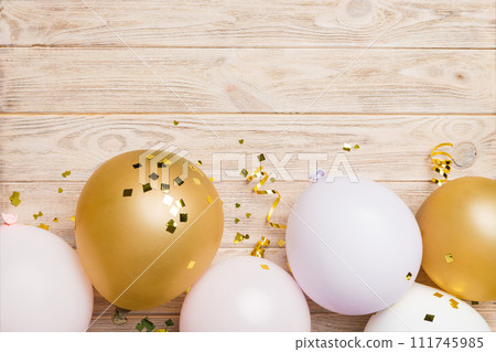 Background with fastive air balloons of round shape and confetti, multicoloured top view. Birthday party background 111745985