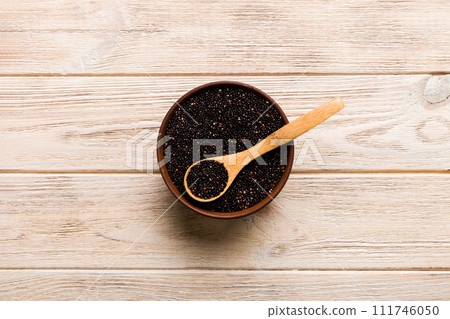 quinoa seeds in bowl and spoon on colored background. Healthy kinwa in small bowl. Healthy superfood 111746050