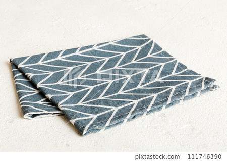 top view with blue kitchen napkin isolated on table background. Folded cloth for mockup with copy space, Flat lay. Minimal style top view with blue kitchen napkin isolated on table background. Folded cloth for mockup with copy space, Flat lay. Minimal style 111746390