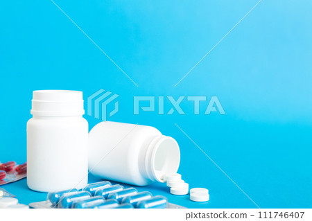 Medicine for treatment HIV infection. Pills and capsules and battle on the table. Different colorful tablets at colored background with copy space Medicine for treatment HIV infection. Pills and capsules and battle on the table. Different colorful tablets at colored background with copy space 111746407