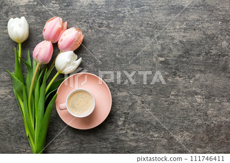 Cup of coffee mug with coffee, cookies and tulips on a colored background. Greeting spring card top view 111746411