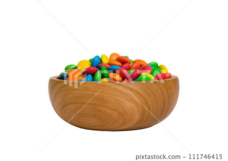 Multicolored candies in a bowl on a colored background. birthday and holiday concept. Top view with copy space Multicolored candies in a bowl on a colored background. birthday and holiday concept. Top view with copy space 111746415