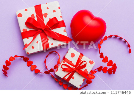 gift box with red bow and red heart on colored background . Top view. Flat lay 111746446