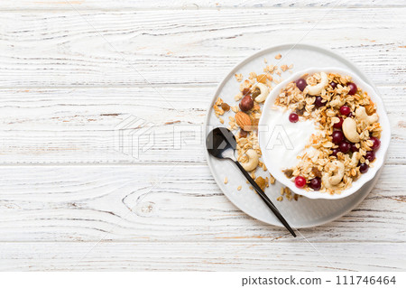 Healthy breakfast food with granola, yogurt, fruits and nuts. Dessert parfait with dried fruits for breakfast Healthy breakfast food with granola, yogurt, fruits and nuts. Dessert parfait with dried fruits for breakfast 111746464