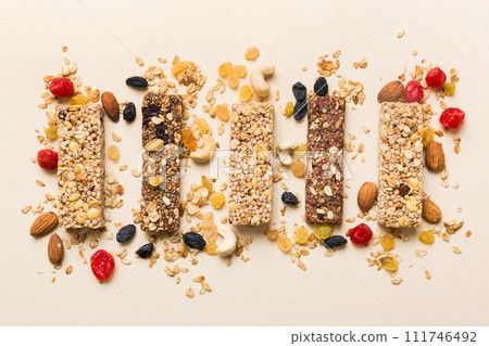 Various granola bars on table background. Cereal granola bars. Superfood breakfast bars with oats, nuts and berries, close up. Superfood concept Various granola bars on table background. Cereal granola bars. Superfood breakfast bars with oats, nuts and berries, close up. Superfood concept 111746492