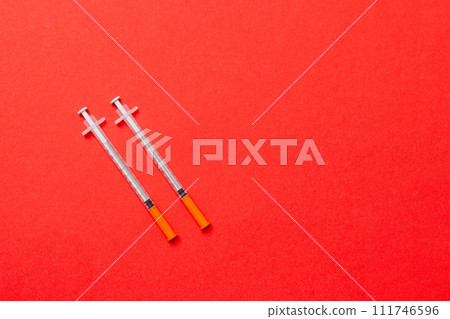 Top view of insulin syringes ready for injection on colorful background. Diabetic concept with copy space Top view of insulin syringes ready for injection on colorful background. Diabetic concept with copy space 111746596