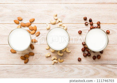 Set or collection of various vegan milk almond, cashew, on table background. Vegan plant based milk and ingredients, top view Set or collection of various vegan milk almond, cashew, on table background. Vegan plant based milk and ingredients, top view 111746703