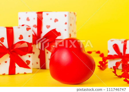 gift box with red bow and red heart on colored background. Perspective view. Flat lay 111746747
