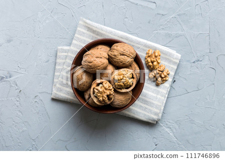 Fresh healthy walnuts in bowl on colored table background. Top view Healthy eating bertholletia concept. Super foods 111746896