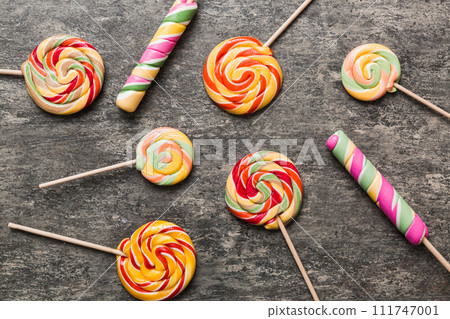 Set of colorful lollipops on colored background. Summer concept. Party Happy Birthday or Minimalist Concept Set of colorful lollipops on colored background. Summer concept. Party Happy Birthday or Minimalist Concept 111747001