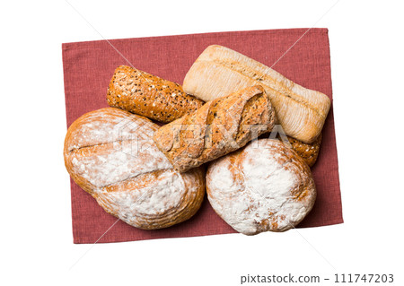 Freshly baked delicious french bread with napkin isolated on white background top view. Healthy white bread loaf Freshly baked delicious french bread with napkin isolated on white background top view. Healthy white bread loaf 111747203