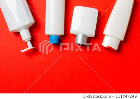 Set of White Cosmetic containers isolated on colored background, top view with copy space. Group of plastic bodycare bottle containers with empty space for you design Set of White Cosmetic containers isolated on colored background, top view with copy space. Group of plastic bodycare bottle containers with empty space for you design 111747249