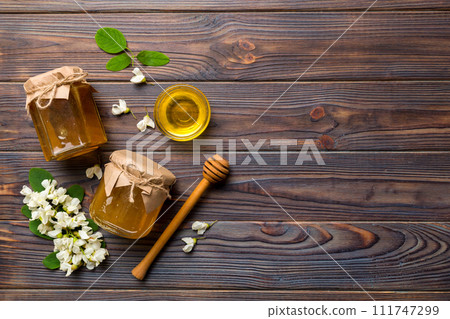 honey jar with acacia flowers and leaves. fresh honey top view flat lay honey jar with acacia flowers and leaves. fresh honey top view flat lay 111747299