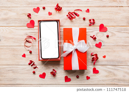 Opened gift box with ribbon and phone on color background, top view. Blank open box packaging mockup , Template for your design - branding mockup 111747518