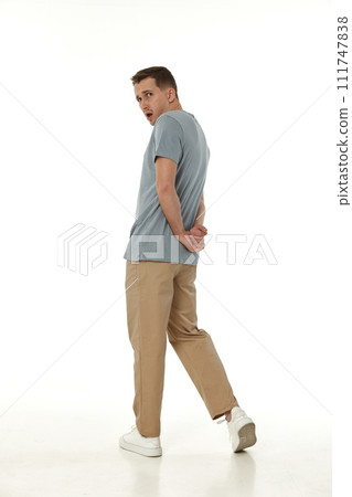 surprised guy looking at camera on white studio background 111747838