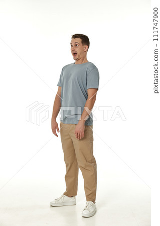 surprised guy looking at camera on white studio background 111747900