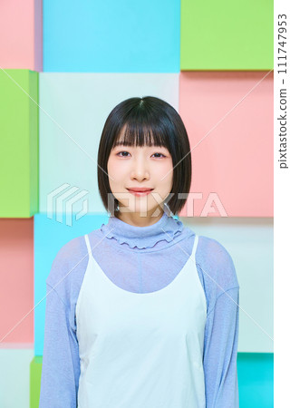 Colorful background with smiling young woman 111747953