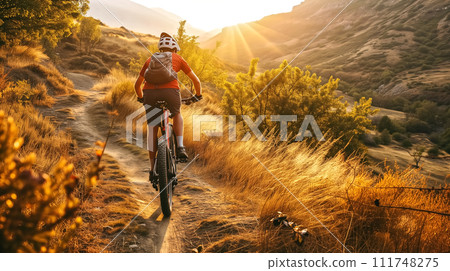 A cyclist enjoys a mountain bike ride on a serene trail during a golden sunset, embodying adventure and freedom. A cyclist enjoys a mountain bike ride on a serene trail during a golden sunset, embodying adventure and freedom. 111748275