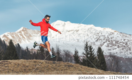 Man jumps running in the mountains Man jumps running in the mountains 111748454