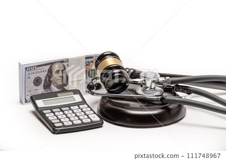 A conceptual image featuring a gavel, cash, and stethoscope symbolizing medical malpractice litigation. 111748967