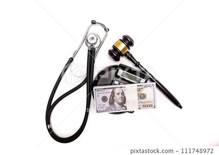 An isolated image of a judge's gavel on a stack of cash with a calculator, signifying legal fines or bail. 111748972