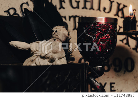 A handmade voodoo doll with pins, set against a rustic backdrop, evoking occult practices. A handmade voodoo doll with pins, set against a rustic backdrop, evoking occult practices. 111748985