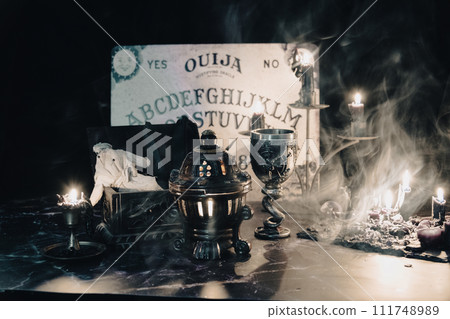 A worn rag doll lies in a haunting occult setting with a Ouija board backdrop, invoking a sense of mystery. A worn rag doll lies in a haunting occult setting with a Ouija board backdrop, invoking a sense of mystery. 111748989