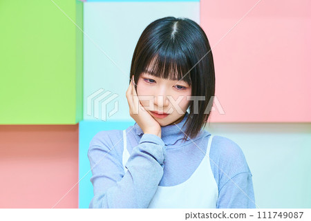 A young woman with a doubtful expression A young woman with a doubtful expression 111749087