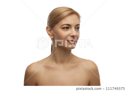 Portrait of smiling beautiful woman with bare shoulders looking away against white studio background. Model with well-kept skin. Portrait of smiling beautiful woman with bare shoulders looking away against white studio background. Model with well-kept skin. 111749375