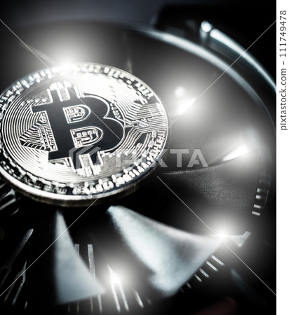 Bitcoin on cooling computer fan background 111749478