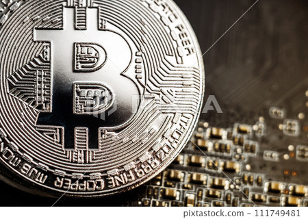 Silver bitcoin on the computer motherboard background 111749481
