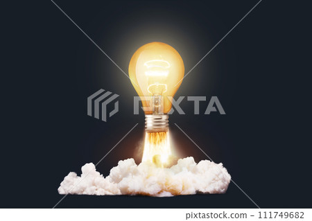 Creative light bulb rocket with blast and clouds takes off on a dark background, concept. Successful launch start up, creative idea. Think differently. Creative generator. Smart and thinking 111749682