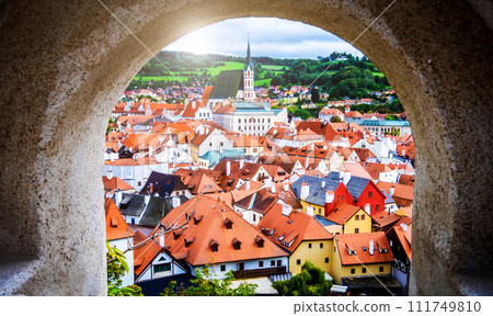 Cesky Krumlov cityscape though stone anchient arch Cesky Krumlov cityscape though stone anchient arch 111749810