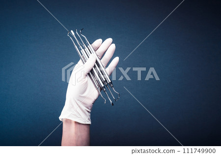 Hand in glove holding medical tools Hand in glove holding medical tools 111749900