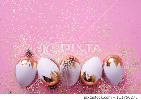 Easter party concept. white Easter eggs with golden glitter on pink background 111750273