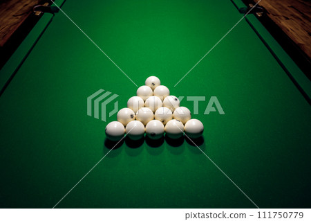 Pyramid of billiard balls on a green canvas 111750779