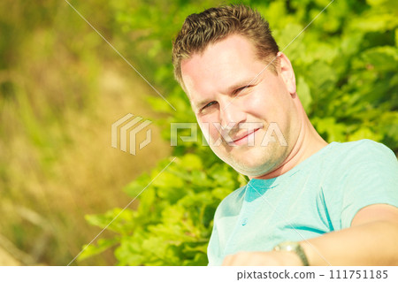 Man spending free time outside, looking at nature Man spending free time outside, looking at nature 111751185