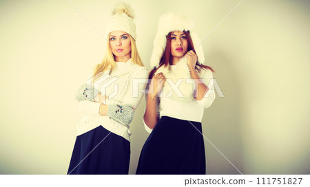 Two women with winter clothes. Two women with winter clothes. 111751827