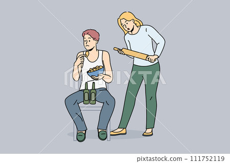 Woman quarrels with slacker husband, who drinks beer and eats chips and does not want to go to job Woman quarrels with slacker husband, who drinks beer and eats chips and does not want to go to job 111752119