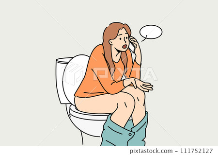 Woman sits on toilet bowl in toilet and talks on phone with friend, discussing colleagues from work 111752127