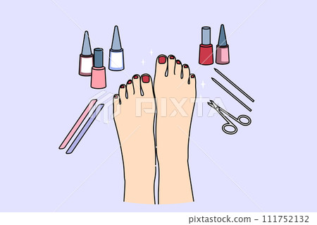 Woman feet after pedicure procedure, with nail polish and scissors near well-groomed painted nails 111752132