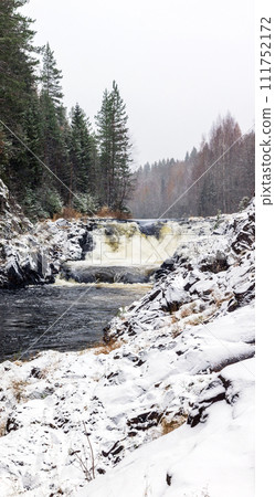 Vertical landscape photo with snowy cascade waterfall. Kivach Falls on a winter day. Suna River 111752172
