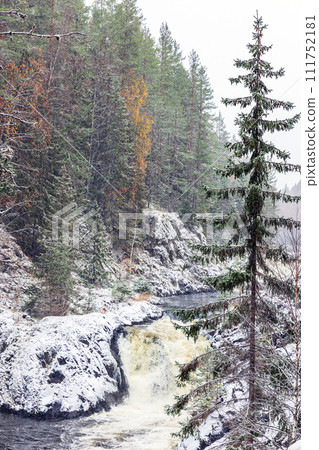 Kivach Falls landscape on a snowy winter day. Vertical photo with cascade waterfall. Suna River 111752181