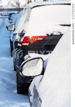 Line of Cars Covered in Snow on a Street Line of Cars Covered in Snow on a Street 111752355