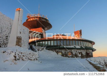 Winter, sunrise time, disc shaped meteorological observatory in snezka, mountain on the border between Czech Republic and Poland. Winter, sunrise time, disc shaped meteorological observatory in snezka, mountain on the border between Czech Republic and Poland. 111752868