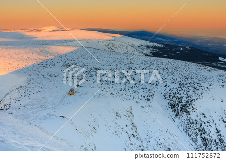 Winter, sunrise time, view from Snezka to Silesian house, krkonose mountains. Snezka is mountain on the border between Czech Republic and Poland. Winter, sunrise time, view from Snezka to Silesian house, krkonose mountains. Snezka is mountain on the border between Czech Republic and Poland. 111752872